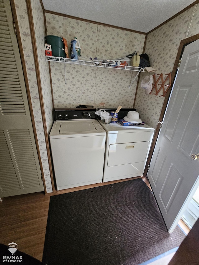 2789 Grass Lake Ave, Clare, MI 48632 - laundry room with wallpapered walls, independent washer and dryer, ornamental molding, and dark wood finished floors