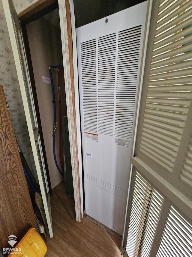 2789 Grass Lake Ave, Clare, MI 48632 - corridor featuring a heating unit and wood finished floors