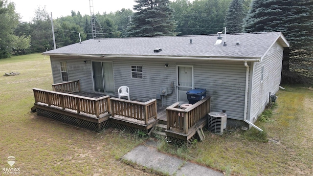 2789 Grass Lake Ave, Clare, MI 48632 - back of property with a yard, a shingled roof, and a deck