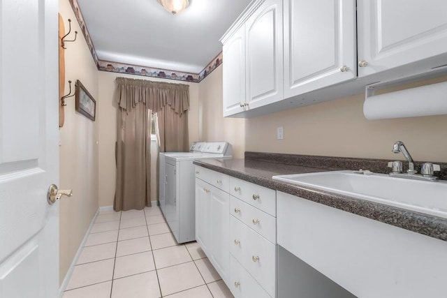 310 Sycamore St, Litchfield, MI 49252 - washroom featuring separate washer and dryer, light tile patterned floors, and cabinet space