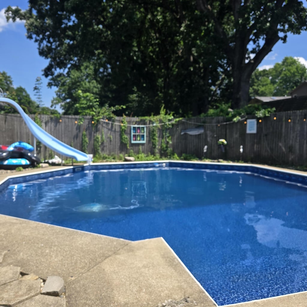 214 Morningside Dr, Battle Creek, MI 49015 - view of pool with a water slide and a fenced backyard