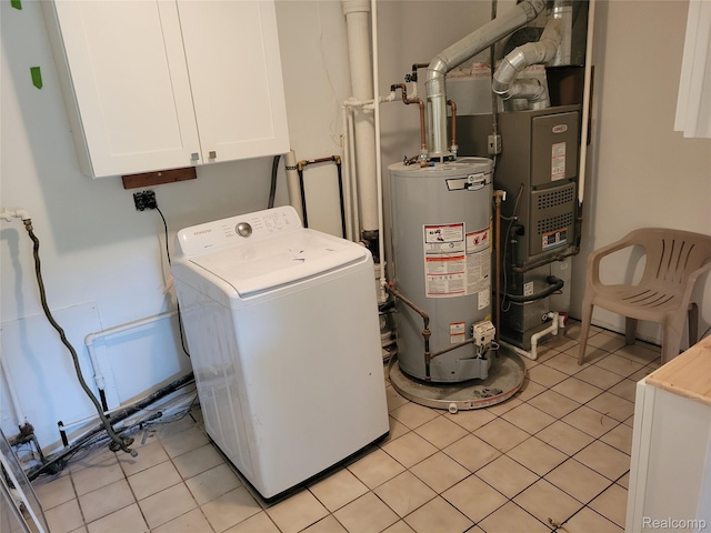 112 Darragh Dr, Battle Creek, MI 49015 - laundry area featuring washer / clothes dryer, gas water heater, cabinet space, and light tile patterned floors
