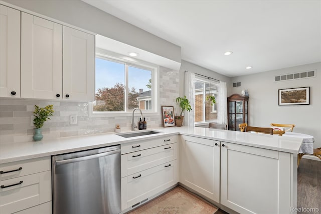 455 Baldwin Ave Unit 203, Rochester, MI 48307 - kitchen featuring stainless steel dishwasher, a peninsula, backsplash, light countertops, and recessed lighting