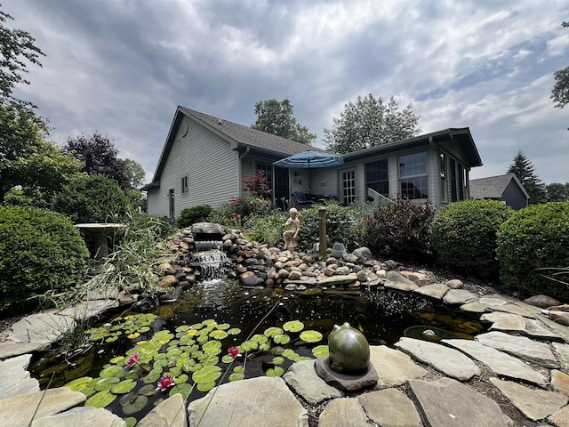 3118 Birch Run, Adrian, MI 49221 - rear view of house with a garden pond