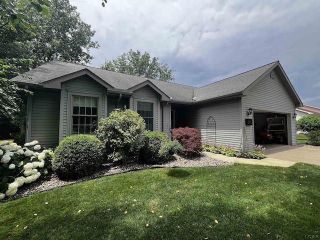 3118 Birch Run, Adrian, MI 49221 - ranch-style house with an attached garage, a front yard, driveway, and roof with shingles