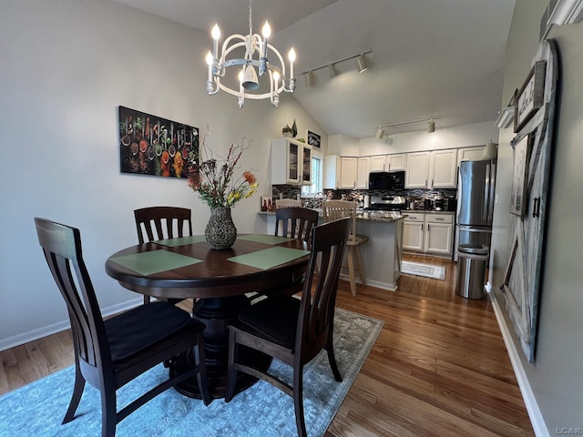 3118 Birch Run, Adrian, MI 49221 - dining space with track lighting, dark wood-type flooring, and a chandelier