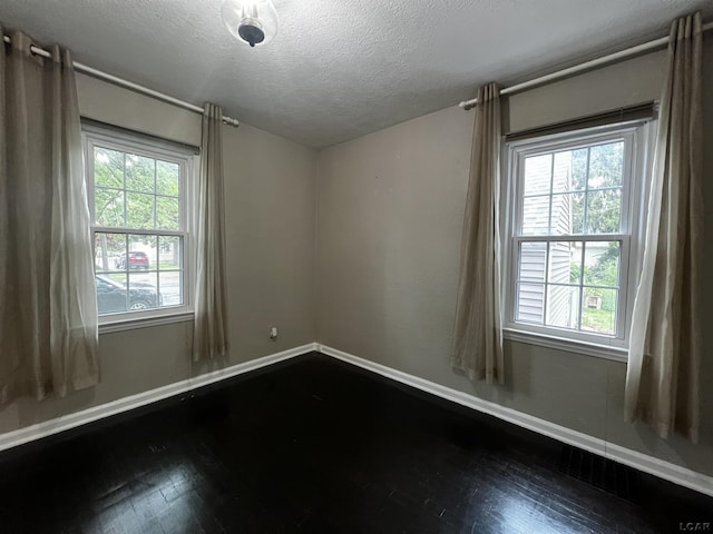 1370 University Ave, Adrian, MI 49221 - spare room with a textured ceiling and dark wood finished floors