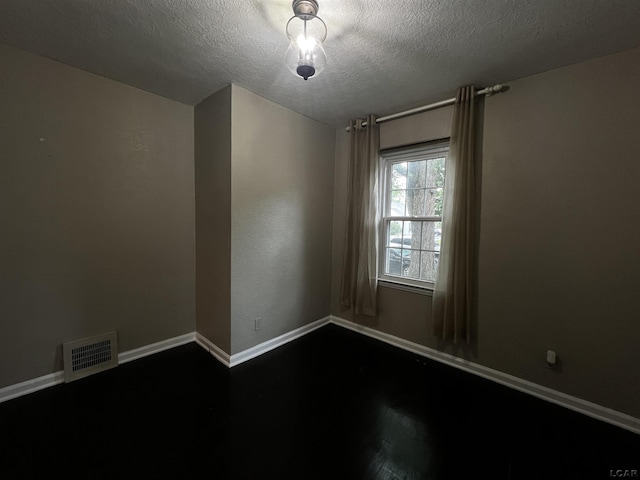 1370 University Ave, Adrian, MI 49221 - empty room featuring wood finished floors and a textured ceiling