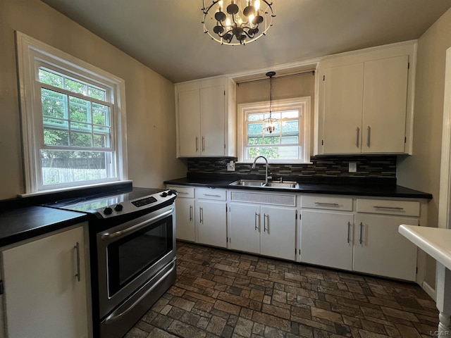 1370 University Ave, Adrian, MI 49221 - kitchen with stainless steel range with electric cooktop, a chandelier, dark countertops, and healthy amount of natural light