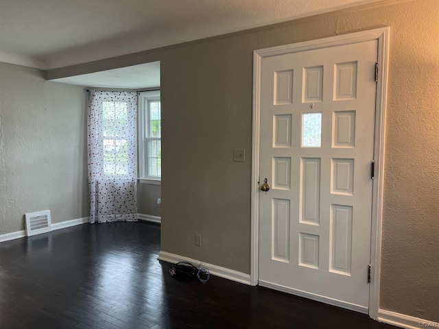 1370 University Ave, Adrian, MI 49221 - entrance foyer with a textured wall and dark wood-type flooring