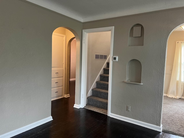 1370 University Ave, Adrian, MI 49221 - spare room with arched walkways, wood finished floors, a textured wall, stairs, and crown molding