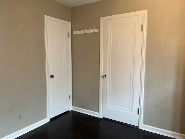 1370 University Ave, Adrian, MI 49221 - unfurnished bedroom with dark wood-style flooring