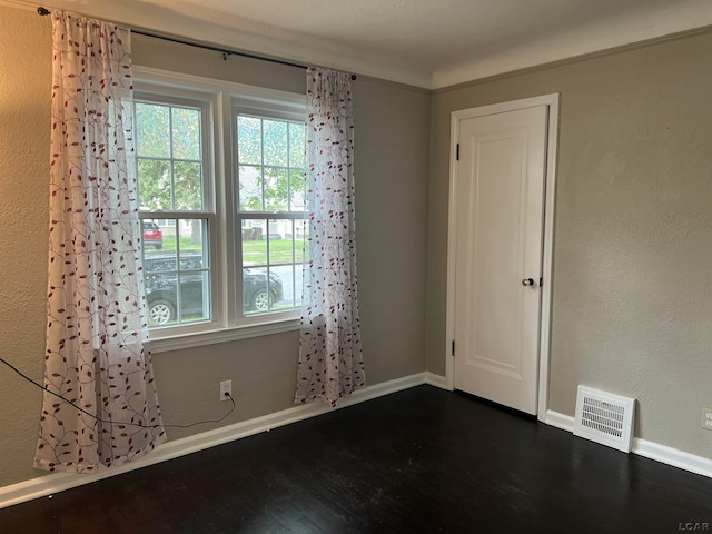 1370 University Ave, Adrian, MI 49221 - empty room featuring dark wood-type flooring and baseboards