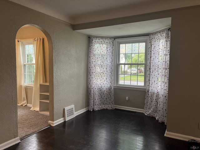 1370 University Ave, Adrian, MI 49221 - unfurnished room featuring a textured wall, arched walkways, and wood finished floors