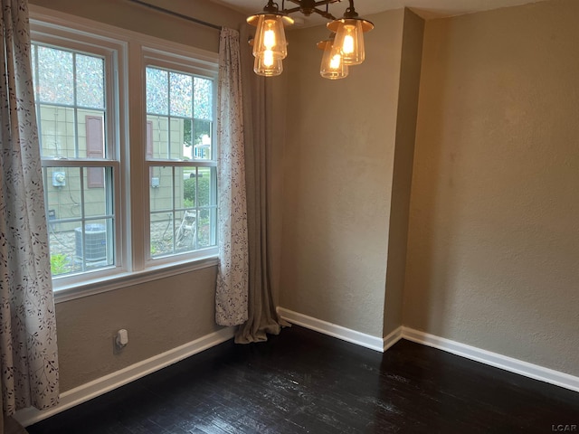 1370 University Ave, Adrian, MI 49221 - spare room featuring dark wood finished floors and a textured wall