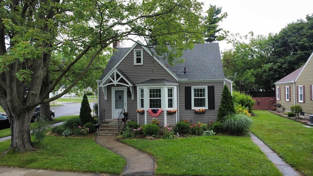 1370 University Ave, Adrian, MI 49221 - bungalow-style house featuring a shingled roof, a front lawn, and a chimney