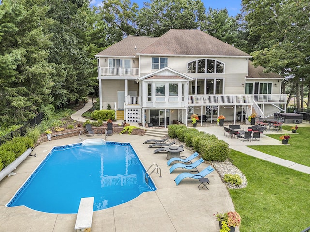 15518 Oak Ridge Dr, Spring Lake, MI 49456 - rear view of house with stairs, a patio, a hot tub, and a balcony