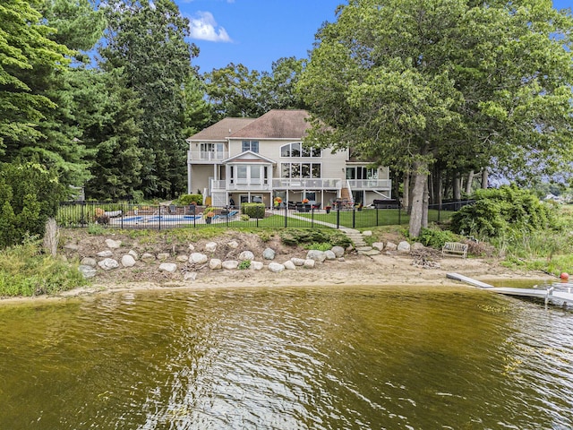 15518 Oak Ridge Dr, Spring Lake, MI 49456 - back of property featuring a water view, a fenced backyard, and stairs