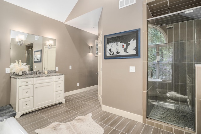 15518 Oak Ridge Dr, Spring Lake, MI 49456 - bathroom with vanity, a stall shower, and vaulted ceiling