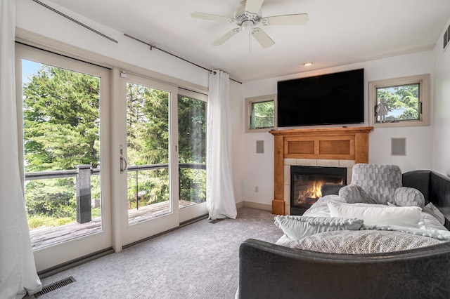 15518 Oak Ridge Dr, Spring Lake, MI 49456 - living area with healthy amount of natural light, a tiled fireplace, and light carpet