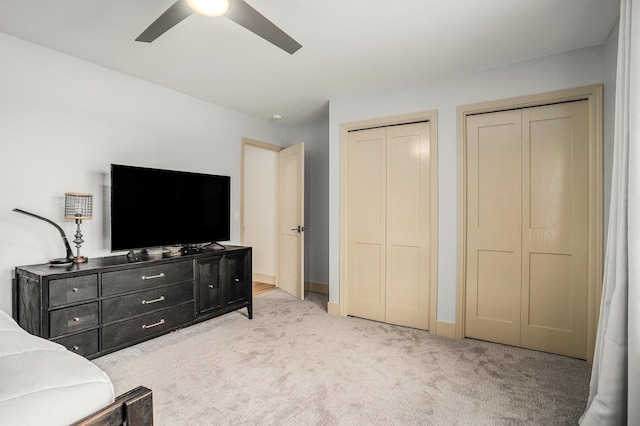 15518 Oak Ridge Dr, Spring Lake, MI 49456 - bedroom with multiple closets, light colored carpet, and ceiling fan