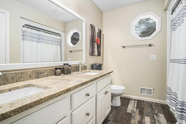 15518 Oak Ridge Dr, Spring Lake, MI 49456 - bathroom with wood finished floors, double vanity, and curtained shower