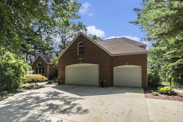 15518 Oak Ridge Dr, Spring Lake, MI 49456 - traditional-style house featuring concrete driveway, a garage, brick siding, and a shingled roof