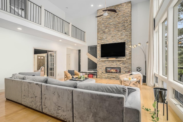 15518 Oak Ridge Dr, Spring Lake, MI 49456 - living area featuring a high ceiling, wood finished floors, a fireplace, healthy amount of natural light, and recessed lighting