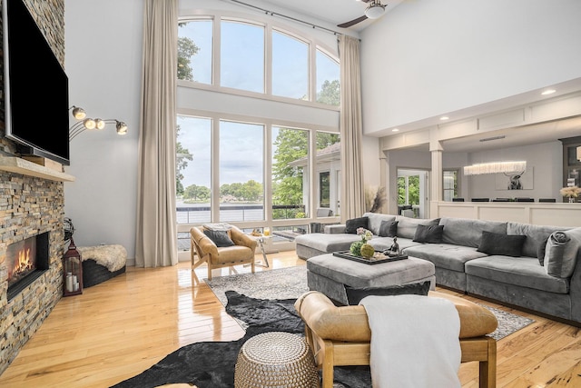 15518 Oak Ridge Dr, Spring Lake, MI 49456 - living area featuring a high ceiling, a fireplace, hardwood / wood-style flooring, and plenty of natural light