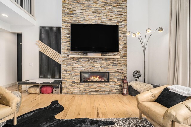 15518 Oak Ridge Dr, Spring Lake, MI 49456 - living area featuring wood finished floors and a stone fireplace