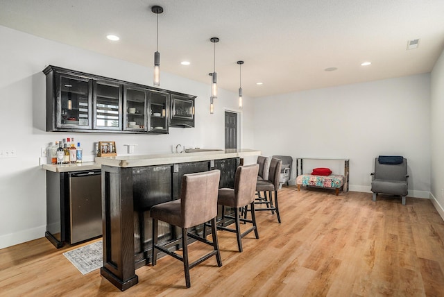 15518 Oak Ridge Dr, Spring Lake, MI 49456 - indoor wet bar with light wood-style flooring, decorative light fixtures, and recessed lighting