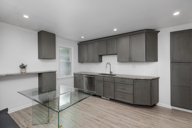 21560 Poinciana St, Southfield, MI 48033 - kitchen with dishwasher, backsplash, light stone counters, light wood-type flooring, and recessed lighting