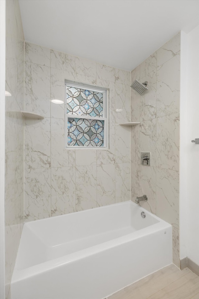 21560 Poinciana St, Southfield, MI 48033 - bathroom featuring washtub / shower combination and wood finished floors