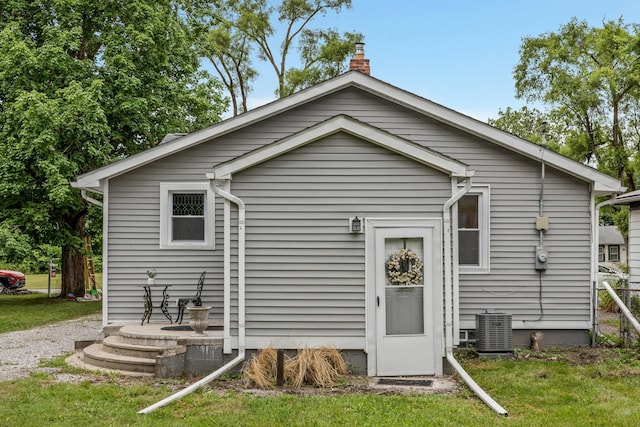 21560 Poinciana St, Southfield, MI 48033 - rear view of house with a chimney and a yard