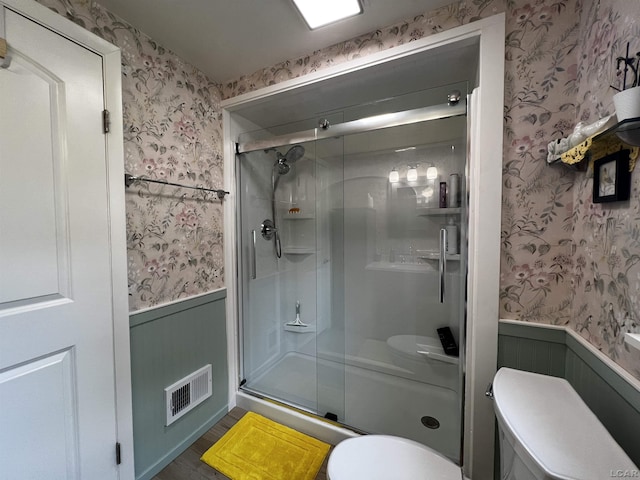 231 Willis Rd, Saline, MI 48176 - bathroom with wallpapered walls, a wainscoted wall, a stall shower, and wood finished floors