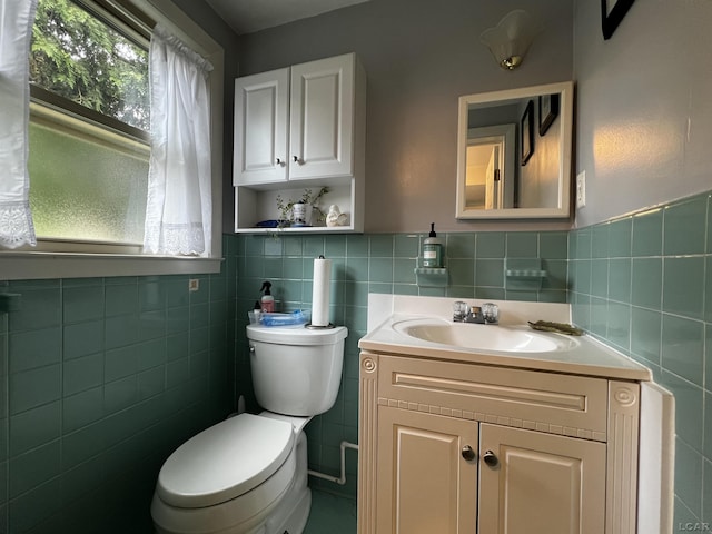 231 Willis Rd, Saline, MI 48176 - bathroom featuring tile walls, vanity, and a wainscoted wall