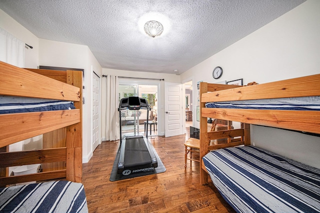 14300 Ridgemont St, Gregory, MI 48137 - bedroom with a textured ceiling and wood finished floors
