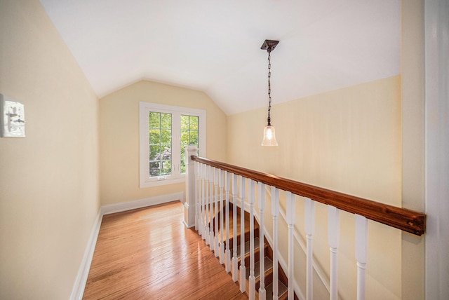 14300 Ridgemont St, Gregory, MI 48137 - corridor with light wood-type flooring, vaulted ceiling, and an upstairs landing