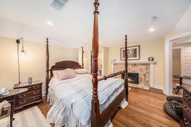 14300 Ridgemont St, Gregory, MI 48137 - bedroom featuring wood finished floors, recessed lighting, and a fireplace