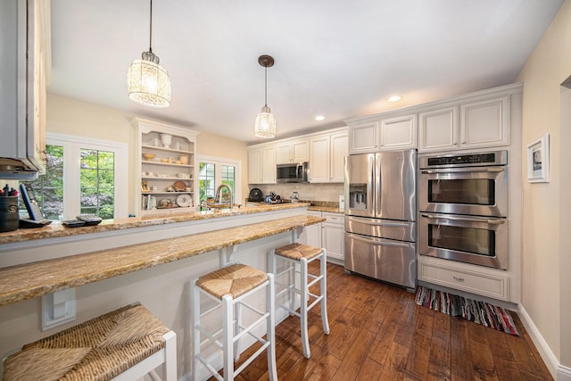 14300 Ridgemont St, Gregory, MI 48137 - kitchen featuring appliances with stainless steel finishes, plenty of natural light, dark wood-style flooring, a breakfast bar, and recessed lighting