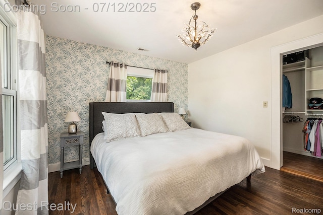 2577 John R Rd, Rochester Hills, MI 48307 - bedroom with wallpapered walls, a chandelier, wood finished floors, and a walk in closet