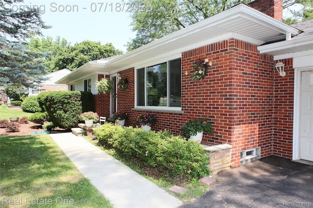 483 Rochdale Dr S, Rochester Hills, MI 48309 - view of property exterior with a chimney, brick siding, and a garage