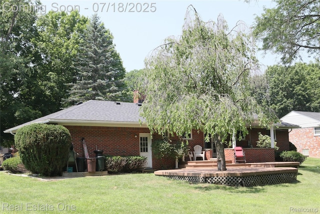 483 Rochdale Dr S, Rochester Hills, MI 48309 - rear view of house with a wooden deck, a lawn, brick siding, roof with shingles, and a chimney