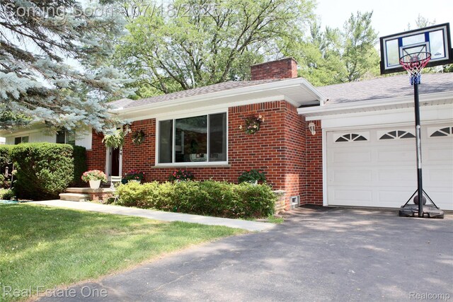 483 Rochdale Dr S, Rochester Hills, MI 48309 - view of front of home with brick siding, a chimney, asphalt driveway, a garage, and roof with shingles