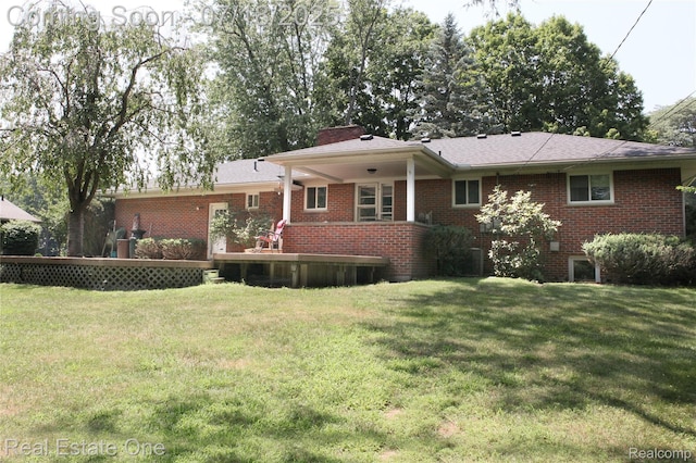 483 Rochdale Dr S, Rochester Hills, MI 48309 - back of house featuring brick siding, a yard, and a chimney