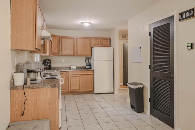 935 N Ave, Battle Creek, MI 49017 - kitchen featuring white appliances, light tile patterned floors, and light brown cabinets