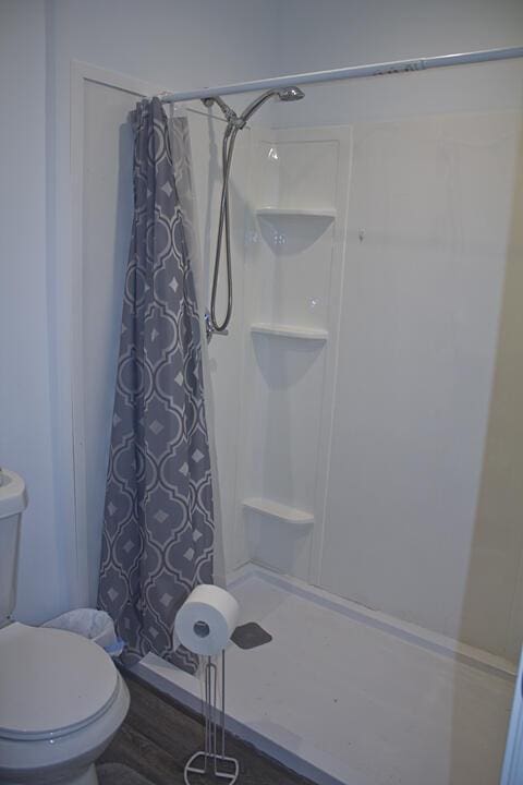 93402 Lee Dr Unit 1, Dowagiac, MI 49047 - full bathroom with a shower with shower curtain and toilet