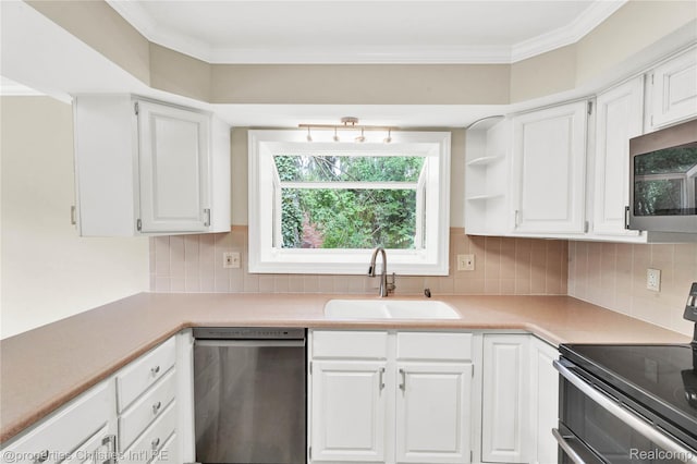 4770 Hedgewood Dr, Bloomfield Hills, MI 48301 - kitchen featuring appliances with stainless steel finishes, white cabinetry, light countertops, crown molding, and backsplash