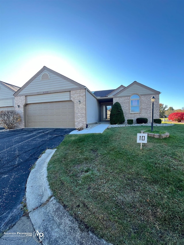 9330 Pinecrest Ct, Davison, MI 48423 - single story home featuring a garage, asphalt driveway, brick siding, and a front lawn