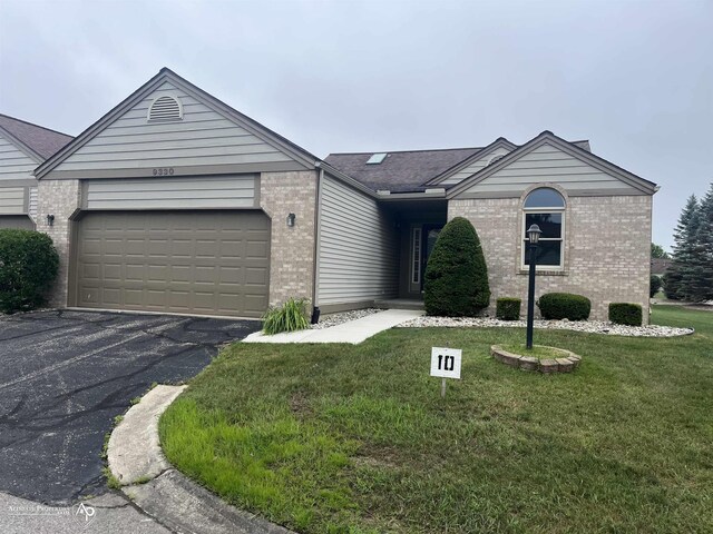 9330 Pinecrest Ct, Davison, MI 48423 - ranch-style home with brick siding, asphalt driveway, a front lawn, and a garage